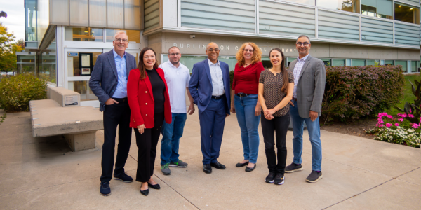 Seven board members standing outside Burlington Public Library's Central Branch