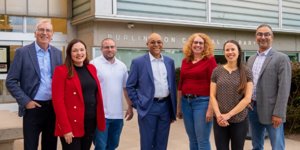 Seven board members standing outside Burlington Public Library's Central Branch