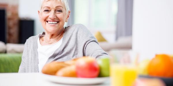 various fruit on a plate in front of a seated adult