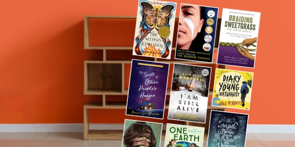 orange wall with a bookshelf with various book covers