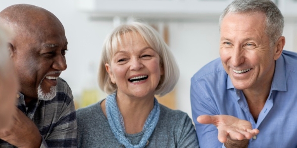 three older adults talking