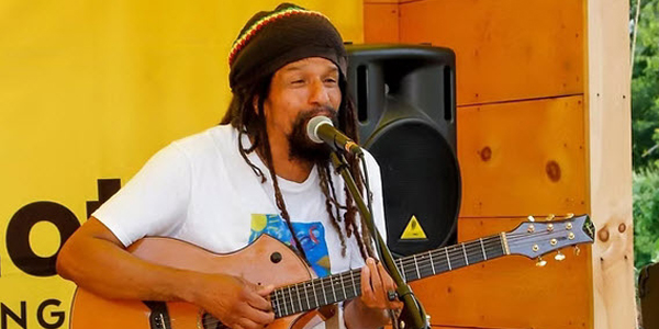 adult musician playing a guitar