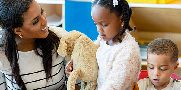 adult talking to two young children