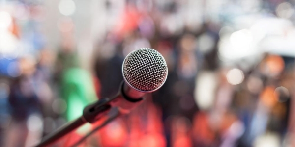 microphone on a stand in front of a crowd