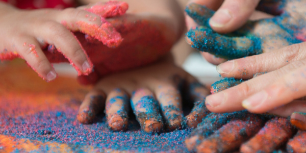 two pairs of hands covered in glitter