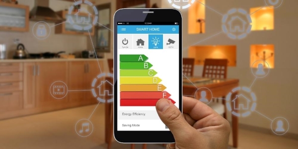 smartphone showing an energy savings app with a kitchen in the background
