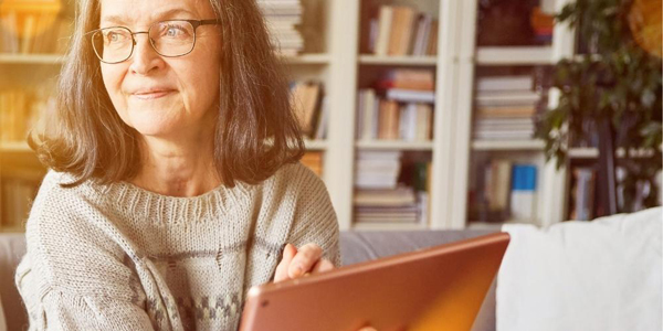 older woman holding an electronic device