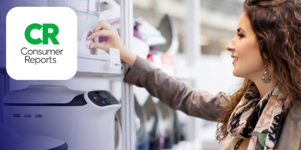 adult touching the dial of a kitchen appliance on a store shelf