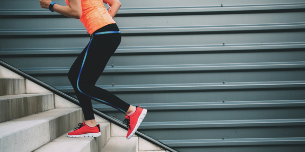 person in athletic clothing running up stairs