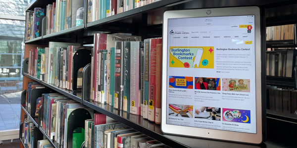 ipad pro sitting on library bookshelf