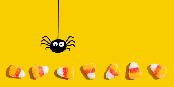 candy corn below an illustrated black spider