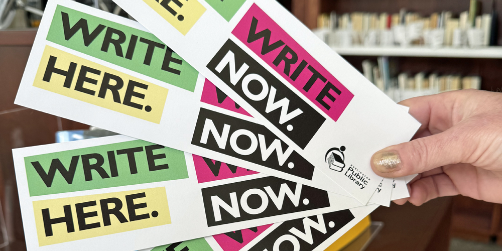 hand holding Write Here Write Now bookmarks