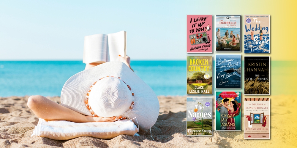 person laying on a sandy beach reading a book beside various book covers and water in the background