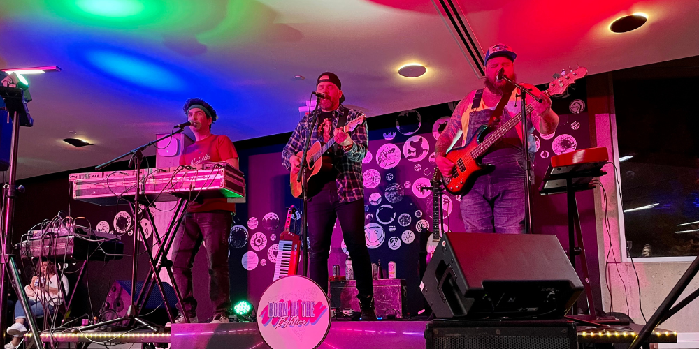 band on stage with coloured lights