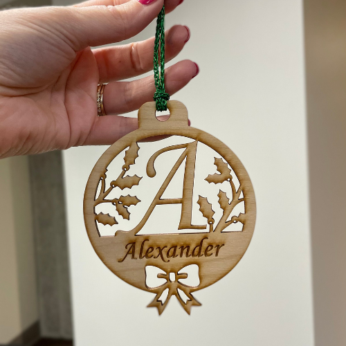 Wooden ornament engraved with "A" and "Alexander"