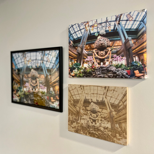 Three framed pictures on a wall of a carved idol