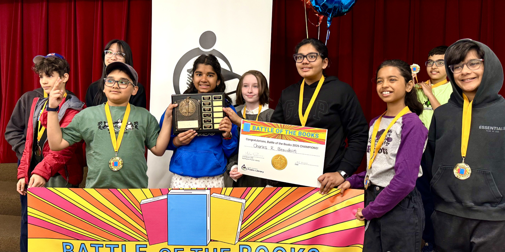 group of students holding a plaque, banner, and certificate