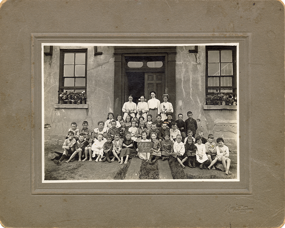 class of students sitting in front of a doorway
