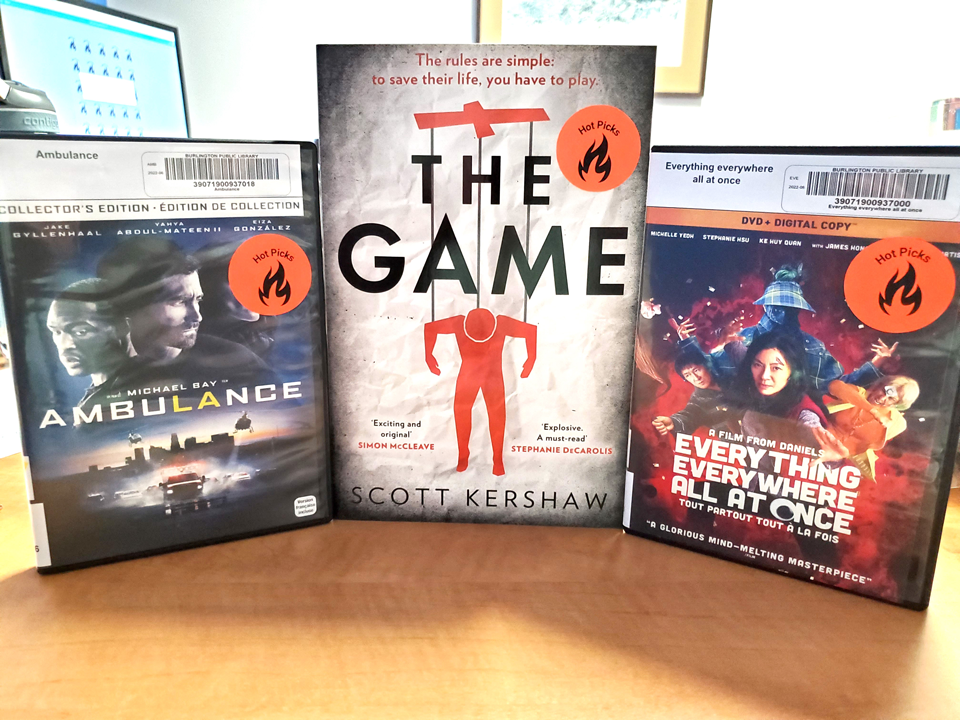 Photo of three books, each with a red flame sticker on the cover
