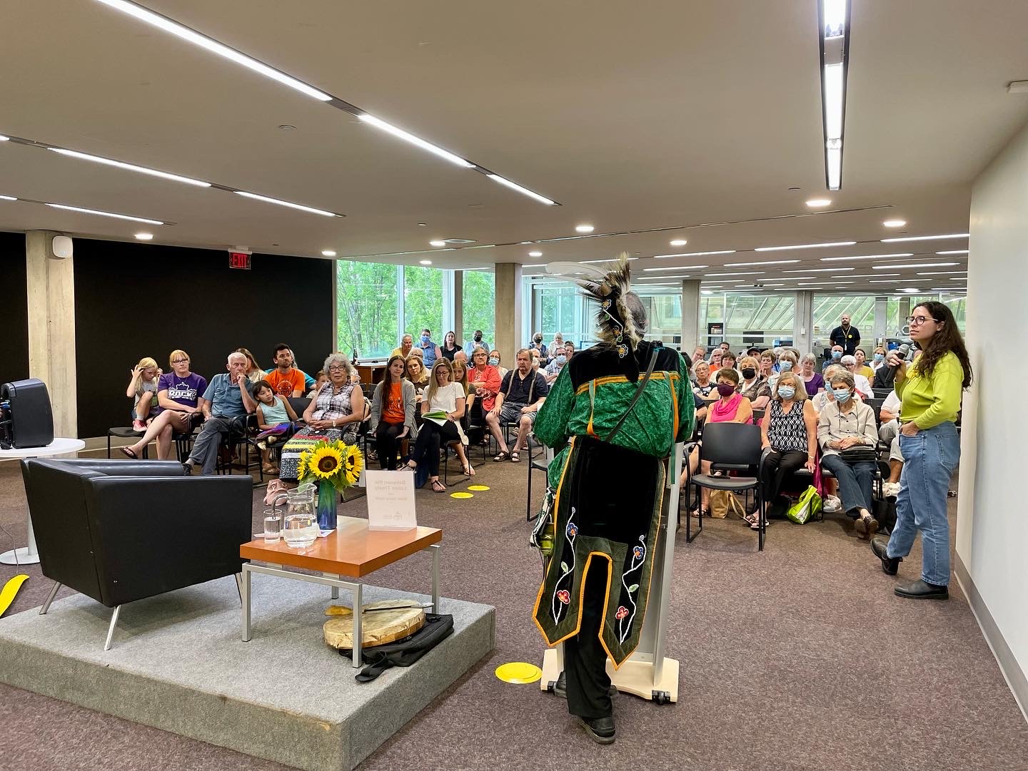 A large crowd of people facing Elder Garry Sault.