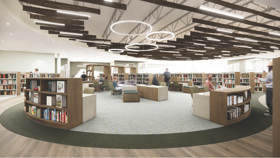 A circular area bordered by bookshelves with high ceilings and desk space