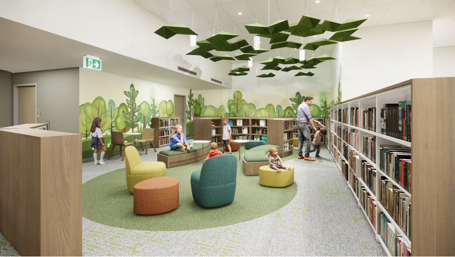 A children's area with trees decor on the walls and colourful, soft chairs