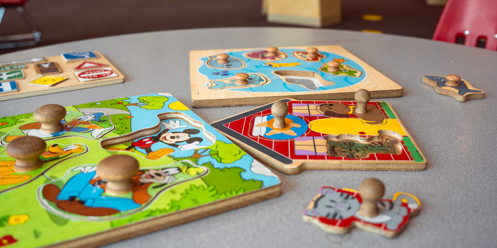 various wood puzzles and pieces on a table