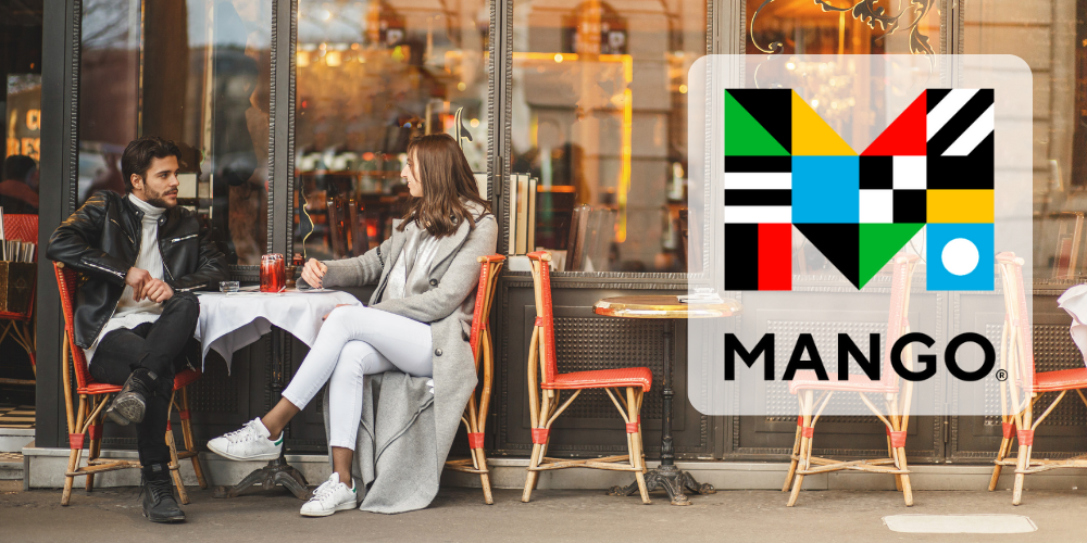 Man and woman sitting outside a cafe. Mango Languages logo on right hand side.