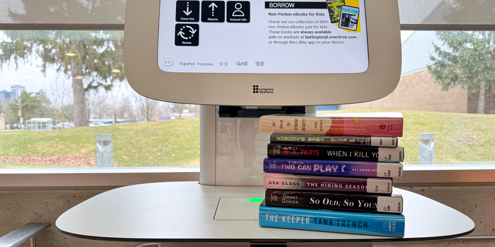 stack of various book at the checkout computer
