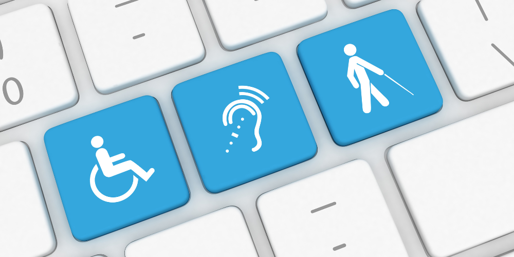 close-up of a white computer keyboard with three blue keys depicting icons for wheelschair, hearing, and white cane