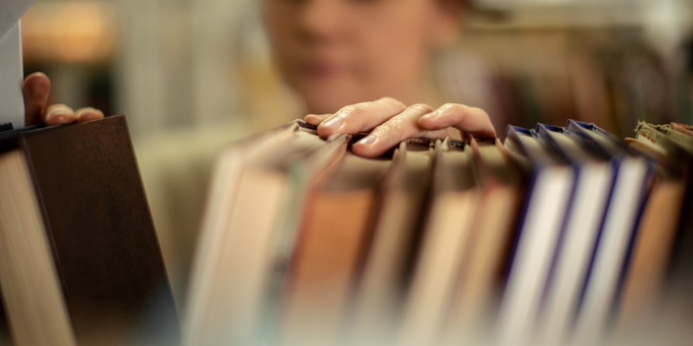 library bookshelf with person in background