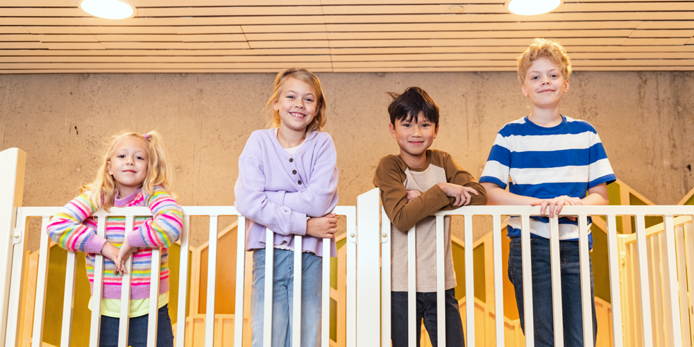 four youth standing at a railing