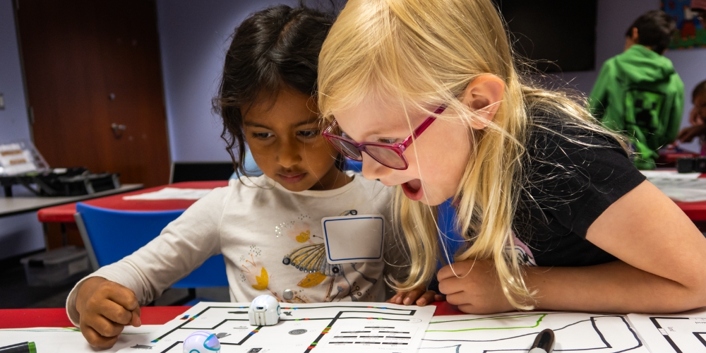 two children looking at a STEAM activity at BPL Central branch