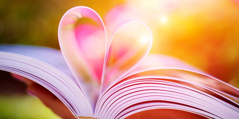 an open book with centre pages folded into a heart shape