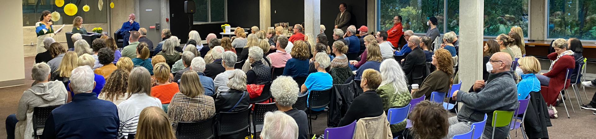 seated audience watching library ceo lita barrie and author douglas stuart on stage in conversation