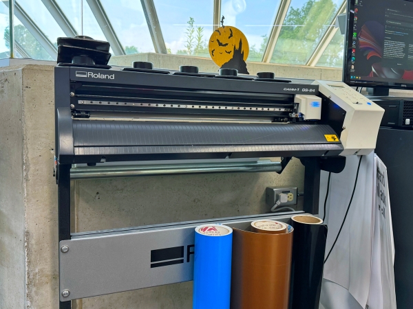 vinyl cutter with rolls of blue, copper, and black vinyl